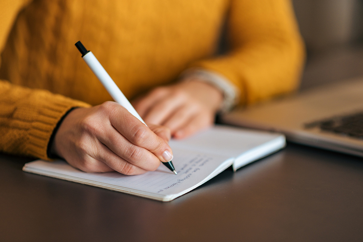 Writing in notebook, Principal's Message
